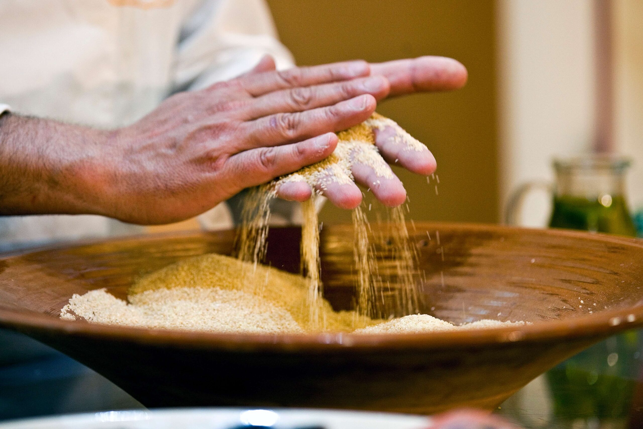 close-up-hands-scattering-wheat
