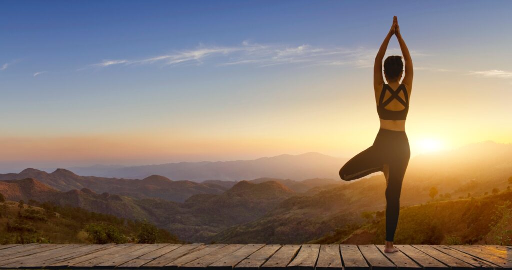 woman with arms outstretched against sky sunset 1